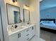 Brightly lit bathroom features a dual sink vanity with white cabinets and hexagon tile floors at 1409 S Moody Ave # 1, Tampa, FL 33629