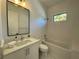 The bathroom features modern fixtures, neutral tile, a quartz countertop and is well-lit at 1409 S Moody Ave # 1, Tampa, FL 33629