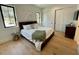 The bedroom is well-lit and features light wood floors, bright windows, and large bed at 1409 S Moody Ave # 1, Tampa, FL 33629