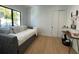 Well-lit bedroom has a daybed and a quaint writing desk, with bright wood floors at 1409 S Moody Ave # 1, Tampa, FL 33629