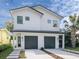 Stunning two-story home with modern design, two-car garage, and fresh landscaping at 1409 S Moody Ave # 1, Tampa, FL 33629