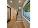 Hallway showcasing staircase with views to a half bathroom and contemporary office at 1409 S Moody Ave # 1, Tampa, FL 33629