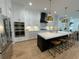 Modern kitchen with stainless steel appliances, a black island, and stylish pendant lighting at 1409 S Moody Ave # 1, Tampa, FL 33629