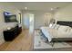 Bright main bedroom with a TV, ensuite bathroom, light wood floors and a geometric area rug at 1409 S Moody Ave # 1, Tampa, FL 33629