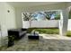The outdoor patio features stylish pavers, a comfortable sofa, and a view of the fenced backyard at 1409 S Moody Ave # 1, Tampa, FL 33629