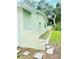 View of the side and rear of the home with a stone walkway and grassy area at 2731 Union S St, St Petersburg, FL 33712