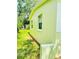 Close up of exterior wall of the home with a green paint color and a window at 2731 Union S St, St Petersburg, FL 33712