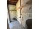 A functional utility room featuring block walls, water pipes, and shelving for storage at 2731 Union S St, St Petersburg, FL 33712