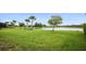 Expansive backyard offers a serene pond view, mature trees, and lush green space, perfect for relaxation and outdoor enjoyment at 13084 Rinella St, Venice, FL 34293