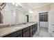 Modern bathroom features double sinks, granite countertops, and a separate shower area, blending style and functionality at 13084 Rinella St, Venice, FL 34293