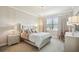 Luxurious bedroom boasts a plush bed, elegant chandelier, and serene ambiance for restful nights and peaceful mornings at 13084 Rinella St, Venice, FL 34293
