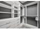 Spacious walk-in closet with custom shelving and storage solutions, optimizing organization and maximizing space at 13084 Rinella St, Venice, FL 34293