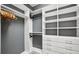 Well-organized walk-in closet featuring ample shelving and hanging space, providing efficient storage for all your belongings at 13084 Rinella St, Venice, FL 34293