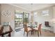 Cozy breakfast nook with a round glass table and scenic views, offering a delightful dining experience at 13084 Rinella St, Venice, FL 34293