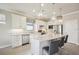 Modern kitchen featuring white cabinets, granite countertops, and a stainless steel refrigerator, designed for convenience at 13084 Rinella St, Venice, FL 34293
