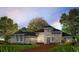 Charming single-story home featuring a symmetrical design, a paved driveway, and a well-manicured lawn at 14215 Suwannee Lake Dr, Dade City, FL 33525