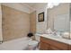 Well-lit bathroom featuring tile accents, a single sink vanity, and a shower-tub combination for comfort and convenience at 11402 Peckham Pl, Tampa, FL 33625