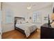 Inviting bedroom with wood floors, neutral walls, plantation shutters and a queen-sized bed with decorative pillows at 11402 Peckham Pl, Tampa, FL 33625