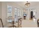 Bright breakfast nook with a glass table, stylish chairs, and view of the outdoor area through large windows and glass doors at 11402 Peckham Pl, Tampa, FL 33625