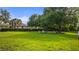 Expansive green common area offers relaxing seating and shade under mature trees for residents' enjoyment at 11402 Peckham Pl, Tampa, FL 33625