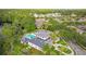 Aerial view of a community pool with lounge chairs, lush landscaping, and nearby residential area at 11402 Peckham Pl, Tampa, FL 33625