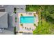 Aerial of a community pool with lounge chairs, manicured landscape, and serene atmosphere at 11402 Peckham Pl, Tampa, FL 33625