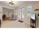 Dining area with travertine floors, access to outdoor patio, a modern light fixture, and comfortable seating at 11402 Peckham Pl, Tampa, FL 33625