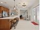 Open dining area featuring hardwood floors, modern light fixture and adjacent to kitchen and sunroom at 11402 Peckham Pl, Tampa, FL 33625