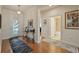 Elegant foyer with hardwood floors, decorative table, and a view of the front door and adjacent bathroom at 11402 Peckham Pl, Tampa, FL 33625