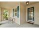 Cozy front porch with seating, shuttered windows, and a decorative front door, creating a welcoming entrance at 11402 Peckham Pl, Tampa, FL 33625