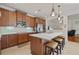 Spacious kitchen with stainless appliances, kitchen island with seating, and wood cabinetry at 11402 Peckham Pl, Tampa, FL 33625