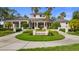 Beautiful lake house entrance with lush landscaping and palm trees, creating a serene and inviting atmosphere at 11402 Peckham Pl, Tampa, FL 33625