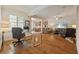 Open-concept living room featuring hardwood floors, modern furniture, and seamless flow to the kitchen at 11402 Peckham Pl, Tampa, FL 33625