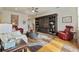 Well-appointed living room with a sofa, area rug, stylish furniture, and a large built-in storage unit at 11402 Peckham Pl, Tampa, FL 33625