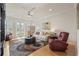 Cozy living room with a plush sofa, accent chairs, area rug, and natural light streaming through the glass doors at 11402 Peckham Pl, Tampa, FL 33625