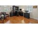 Bright home office with hardwood floors, ample natural light, and a full-sized desk with drawers for storage at 11402 Peckham Pl, Tampa, FL 33625