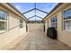 Beautiful outdoor patio with a covered lanai, brick pavers, and ample space for entertaining at 11402 Peckham Pl, Tampa, FL 33625