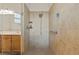 Tiled shower with a glass door, adjustable shower head, grab bar, and built-in shelving at 11402 Peckham Pl, Tampa, FL 33625