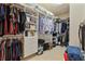 Organized walk-in closet with ample shelving, hanging space, and storage drawers at 11402 Peckham Pl, Tampa, FL 33625