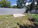 Backyard with a concrete pad, partially enclosed by metal and chain-link fencing at 13 Euclid Dr, Plant City, FL 33563