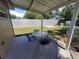 Backyard patio with a table and chairs, enclosed by privacy and chain-link fencing at 13 Euclid Dr, Plant City, FL 33563