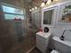 Bathroom features a tiled glass shower, single vanity and new fixtures at 13 Euclid Dr, Plant City, FL 33563