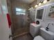 Bathroom features tiled glass shower, single vanity and new fixtures at 13 Euclid Dr, Plant City, FL 33563