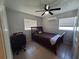 Bedroom with dark wood furnishings, a ceiling fan, and natural light from two windows at 13 Euclid Dr, Plant City, FL 33563