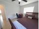 Bedroom shows dark wood bedframe, tile flooring and desk with chair at 13 Euclid Dr, Plant City, FL 33563