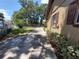 Long driveway extending along the side of the house, leading to a gate and backyard at 13 Euclid Dr, Plant City, FL 33563