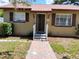 Inviting front porch with steps leading to the front door and a view of the home's exterior at 13 Euclid Dr, Plant City, FL 33563