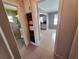 Hallway shows bathroom leading to kitchen with tile flooring at 13 Euclid Dr, Plant City, FL 33563