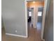 Hallway view leading to bedrooms, showcasing the neutral color scheme and tiled flooring at 13 Euclid Dr, Plant City, FL 33563