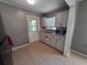 Galley kitchen features neutral color scheme, appliances and sink at 13 Euclid Dr, Plant City, FL 33563
